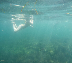 Woman snorkeling Underwater Mediterranean sea in Las Rotas coast marine reserve of San Antonio cape Denia Alicante province Spain