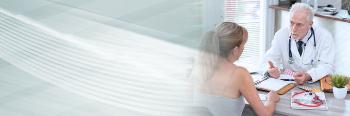 Fototapeta premium Senior doctor explaining treatment to his female patient; panoramic banner