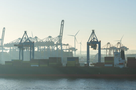 Container terminal and shipping cranes at Hamburg harbor on the Elbe