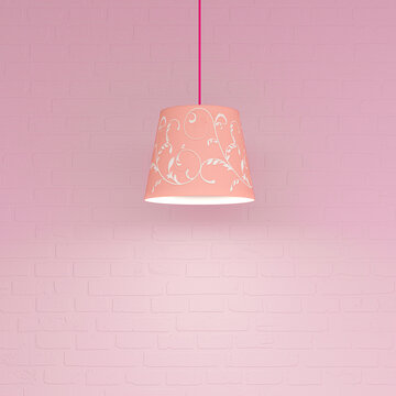 Decorative pink pendant lamp with pattern against pink wall indoors