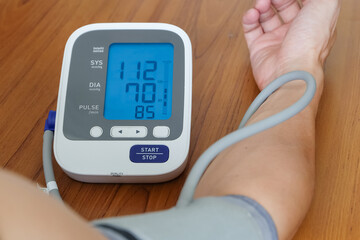 Man check blood pressure monitor and heart rate monitor with digital pressure gauge. Health care and Medical concept	