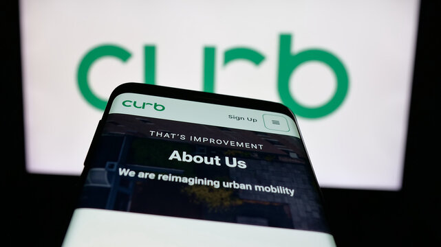 Stuttgart, Germany - 02-02-2026: Mobile phone with website of US taxi app company Curb Mobility LLC on screen in front of logo. Focus on top-left of phone display.