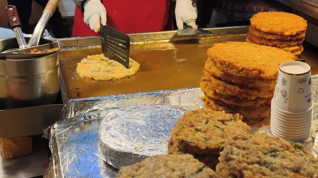 Cooking local delicacies, integral part bustling Korean cuisine. Golden pancakes, popular Korean snacks sold by vendor. Authentic Korean cuisine provides rich cultural, culinary experience.