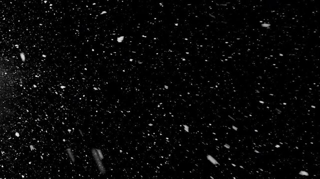 Slow motion of natural snow falling on black background