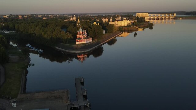 Aerial panoramic view of the historic Uglich Kremlin from above, traveling along the Volga River. Drone shot.