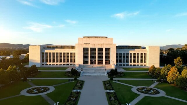 Aerial view of a grand building with symmetrical landscaping during sunset capturing architecture, nature, and scenic beauty