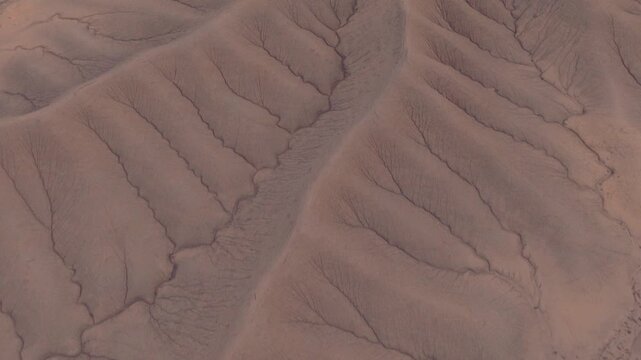 Aerial view of the parched landscape displaying a mesmerizing pattern of ridges and valleys, showcasing nature's artistry, Hanksville, Utah, United States.