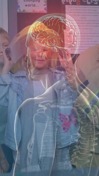 Vertical video: Man placing band on girl, causing anatomy overlay tracking head tilts for class