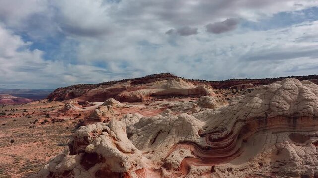 Aerial view of the undulating, otherworldly landscape of White Pocket, with its contrasting white and red sandstone formations, Page, Arizona, United States.