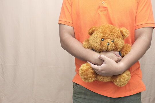 Person hugging teddy bear with copy space