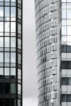 Corporate architecture detail showing modern skyscraper glass facade with offices windows in Paris La Defense urban skyline on daylight