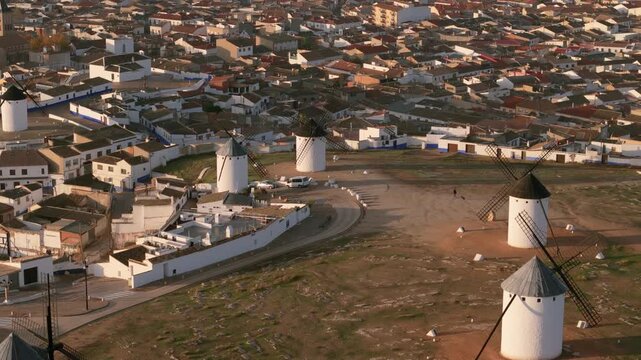 Aerial view of the iconic windmills standing proudly against the backdrop of the clustered buildings in Campo de Criptana, Castile-La Mancha, Spain.
