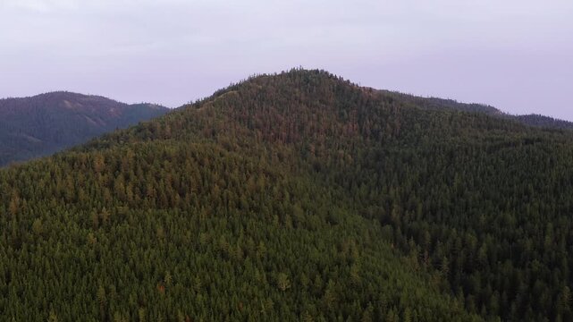 Southern Urals in summer: Southern Kraka ridge, aerial view. Evening fog in the mountains.