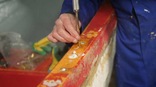 Securing brass wood screw through fiberglass boat gunwale
