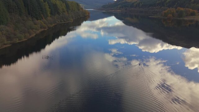 Aerial view of the sky with clouds reflecting on the water, creating a mesmerizing blend of light and dark tones, Callander, Scotland, United Kingdom.