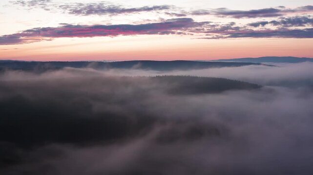 Southern Urals in summer: Southern Kraka ridge, aerial view. Evening fog in the mountains.