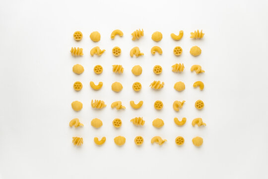 few uncooked pasta types on white background. different pasta, insalata di pasta. texture, food pattern
