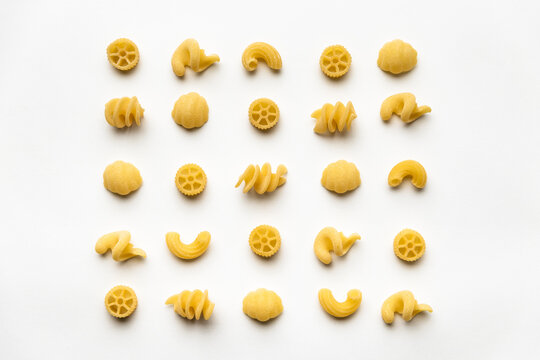 few uncooked pasta types on white background. different pasta, insalata di pasta. texture, food pattern