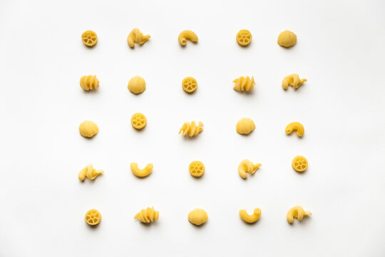 few uncooked pasta types on white background. different pasta, insalata di pasta. texture, food pattern