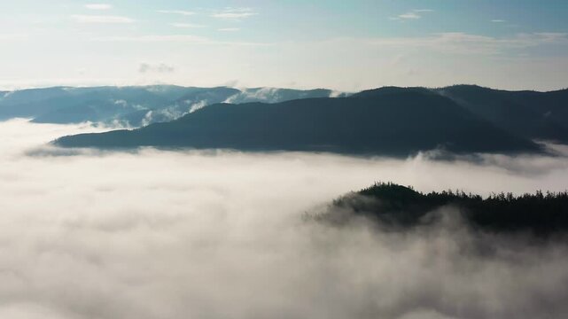 Southern Urals in summer: Southern Kraka ridge, aerial view. Morning fog in the mountains.