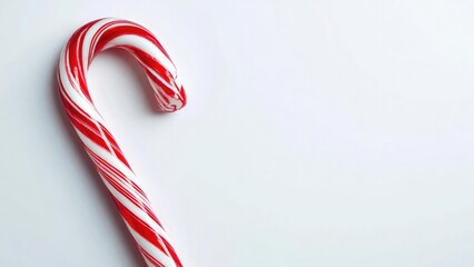 A red-and-white striped candy cane curved in a hook on a pale background. Concept Candy Cane, Christmas Decor, Red and White Stripes, Hooked Shape, Pale Background