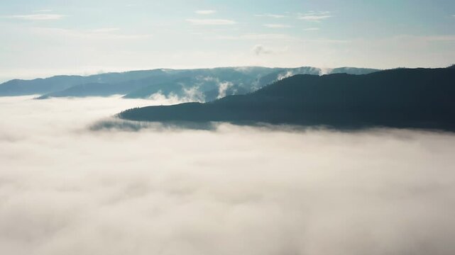 Southern Urals in summer: Southern Kraka ridge, aerial view. Morning fog in the mountains.