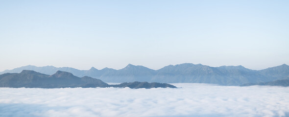Fototapeta premium Misty landscape with forest. Foggy clouds above tree. Panoramic mountain in deep countryside at Thailand. nature background.