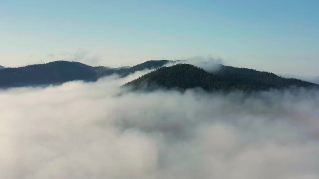 Southern Urals in summer: Southern Kraka ridge, aerial view. Morning fog in the mountains.