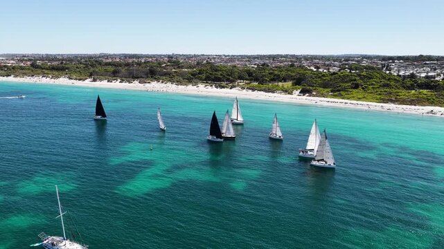 Sailing dinghies off Whitfords Beach, drone flight above the coastline, Perth, Western Australia