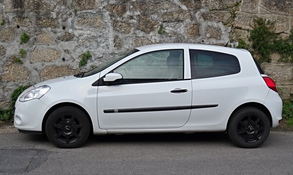 White Renault Clio compact car parked roadside