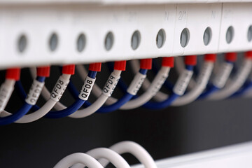 Marking electrical wiring wires with thermally printed nylon tape. 