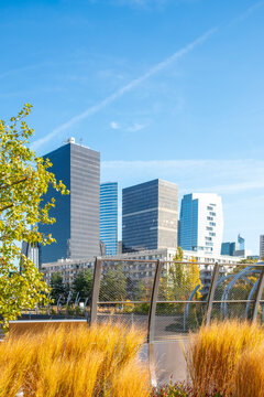 Blue sky over an urban park with grasses and skyline in daylight autumn in Promenade de la Rose de Cherbourg Paris La Defense modern