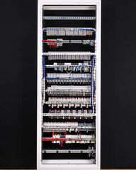 The reverse side of the electrical switchboard. The connected wires are tied with plastic ties.