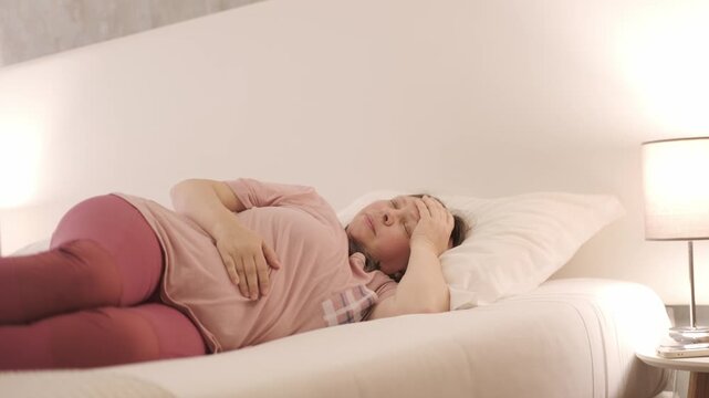 Tired Sleep-deprived woman lies in bed struggles with insomnia, unable to sleep. Sleep disorder, overthinking, restless thoughts deprivation, mental health, sleeping issues, disturbances