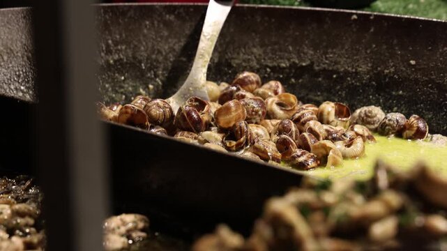 Large pot of snails cooked in the sauce, shellfish meal