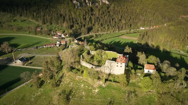 Smooth 4K UHD drone orbit to the right (clockwise circle) around Burgruine Niedergundelfingen on the Schlo&szlig;berg in the Gro&szlig;e Lautertal near M&uuml;nsingen-Gundelfingen, Swabian Alb