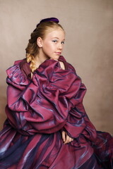 Young Girl in Elegant Avant-Garde Purple Gown