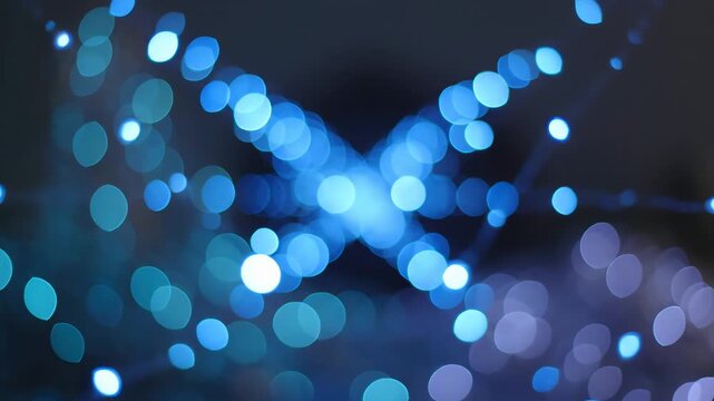 Abstract blue bokeh lights shimmering in the dark, creating a magical and ethereal atmosphere with soft focus and glowing orbs, perfect for a dreamy effect.