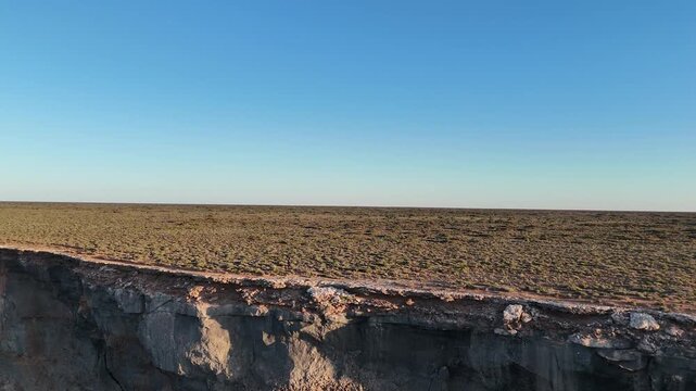 Aerial drone flight from the ocean toward the Bunda Cliffs revealing the vast Nullarbor Plain in South Australia