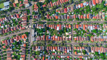 Obraz premium Panoramic Aerial Drone view of Inner Western Suburbs of Sydney housing, roof tops, the streets and the parks, the roads and trees of Ashbury Ashfield Burwood Summer Hill Canterbury and Campsie in Sydn