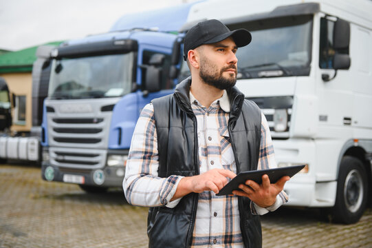 Truck driver using digital tablet managing fleet logistics