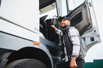 Truck driver smiling getting into semi truck cab
