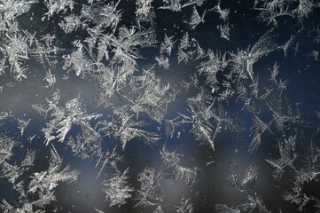 frozen glass with snowflake crystals on it © Александра Дубинина