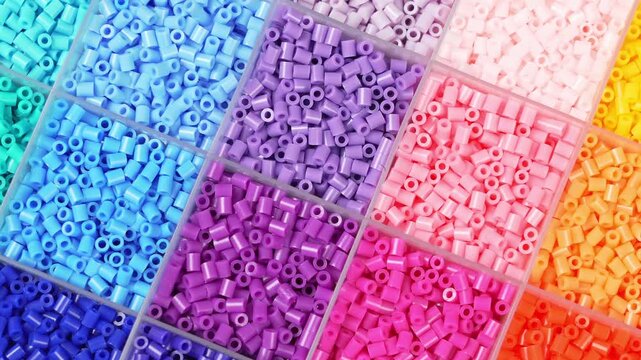 colorful plastic polymer granules on blue background
