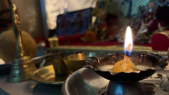 Close-up of a burning diya (oil lamp) during a Hindu prayer ceremony