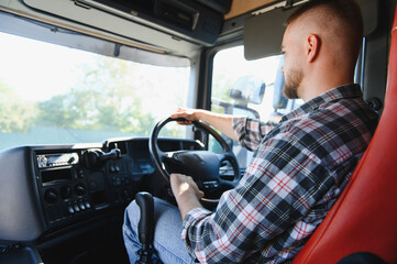 Truck driver steering vehicle on road trip