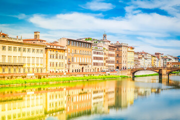 Fototapeta premium old town and river Arno reflecting in water at summer day, Florence, Italy