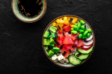 Vegan poke bowl with grapefruit, avocado, mango, edamame, and cucumber