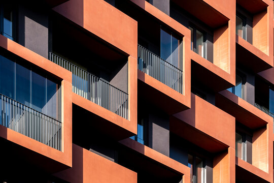 Colorful modern balcony pattern on residential architecture facade in Hamburg Germany with geometric orange modules and deep shadow contrast