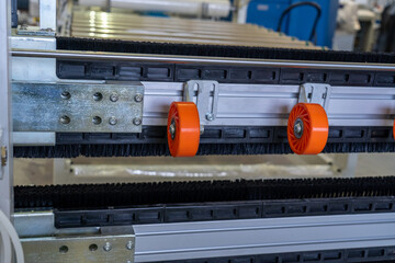 Industrial conveyor rollers and brush system close-up detail in factory